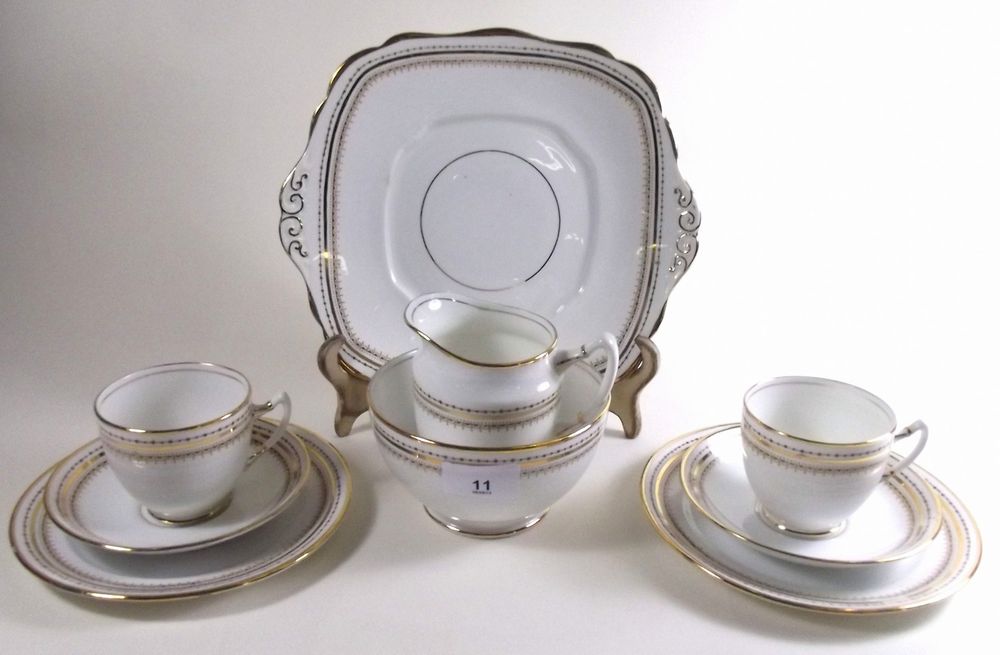 A Royal Albert four place setting gilt and white tea service