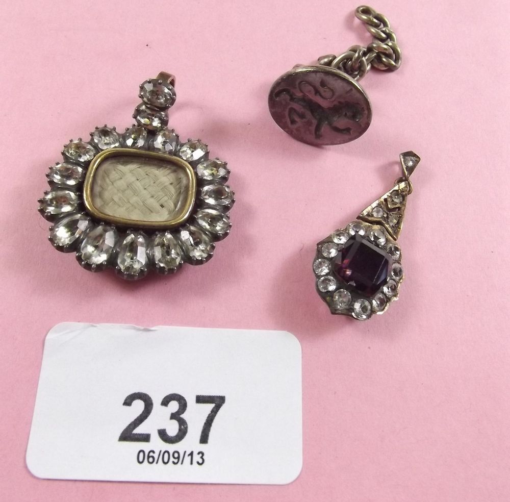 An early 19th century paste and hair locket, an antique paste pendant and a seal