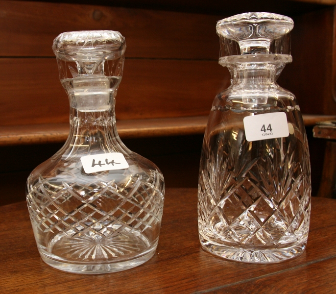 Two cylindrical cut glass decanters