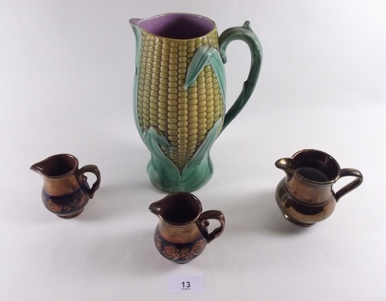 A Victorian Majolica corn on the cob jug and three small copper lustre jugs