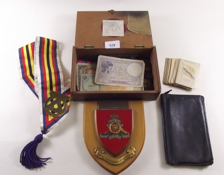A box of coins, notes and RA Regimental plaque