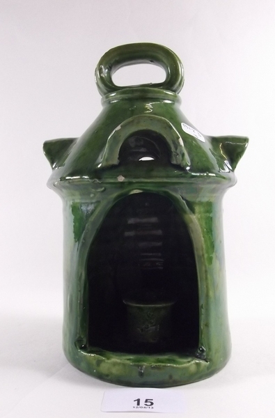 A late Victorian pottery green candle holder