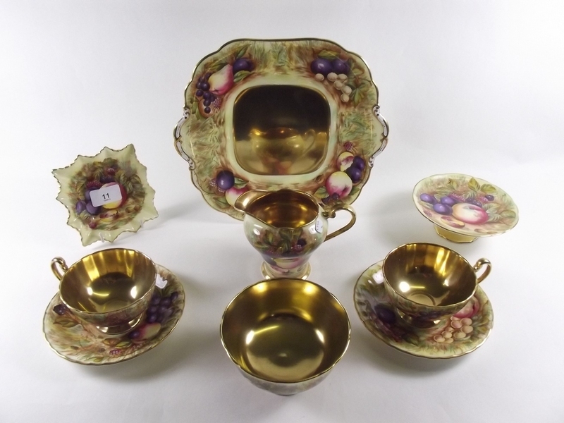 A collection of Aynsley fruit painted teaware comprising five cups and saucers, six teaplates,