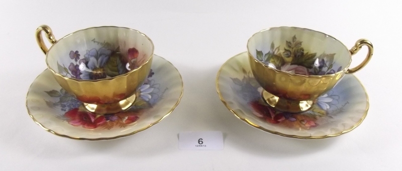 A pair of Aynsley cabinet cups painted flowers