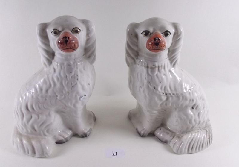 A pair of Victorian Staffordshire poodles, one a/f, 25cm tall