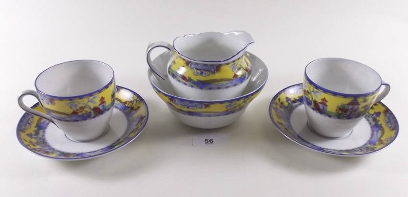 A Czechoslovakian blue and yellow teaset comprising six cups and saucers, sugar, milk and six side