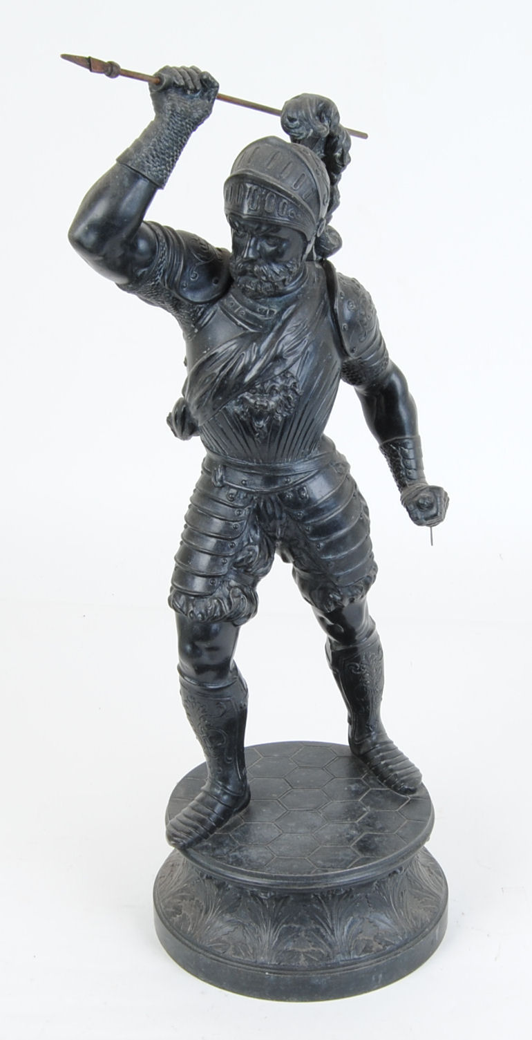 "Spelter figure of a warrior with spear and sword, on raised circular base, 22 ins high"