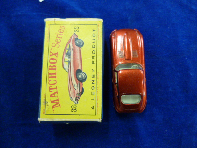 A Matchbox Series No.32 E Type Jaguar, metallic red body, black plastic tyres, in original box, VG-