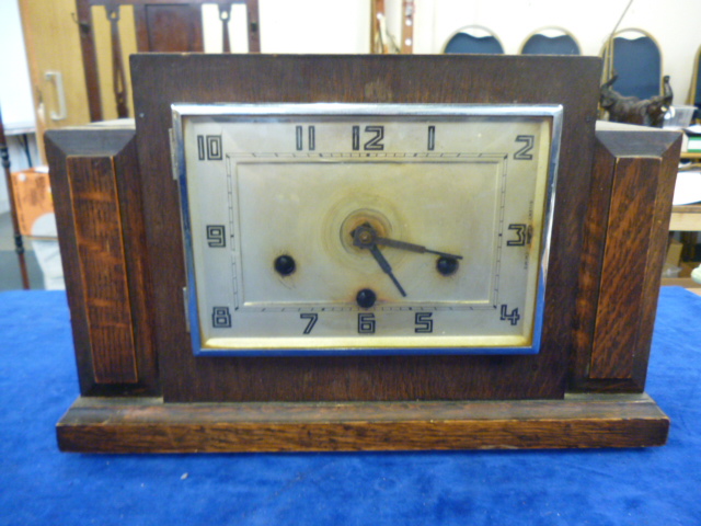 A mahogany Art Deco mantle clock, with geometric design
