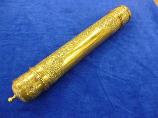 An Indian/Nepalese brass scroll holder.