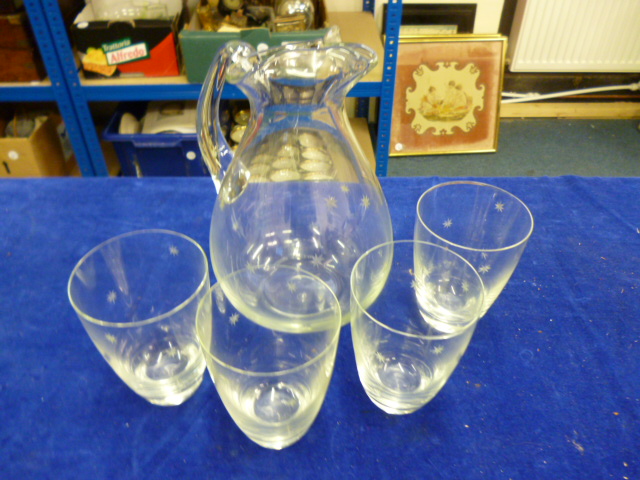 A glass lemonade set with jugs and four glasses with star cut decoration