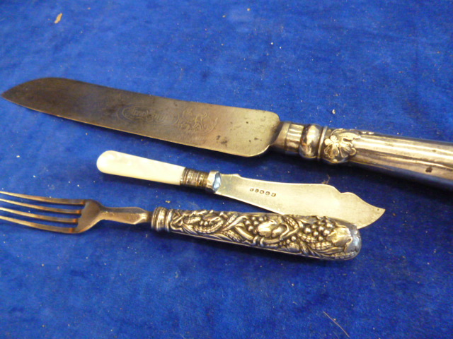 A silver plated handle bread knife together with a Mother of Pearl handled knife and plated fork (3)