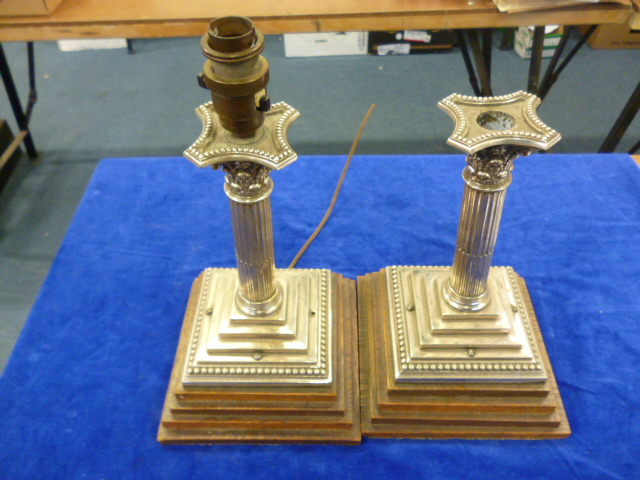 A pair of silver plated candlesticks converted into lamps.