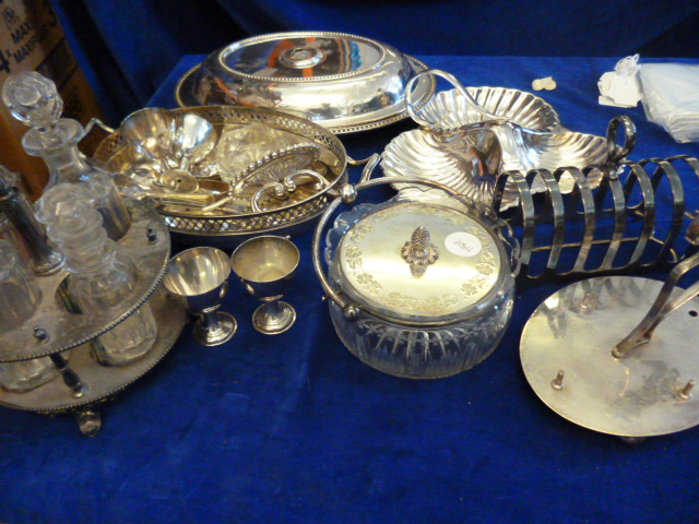 A collection of silver plated and electroplated items including a cruet set with bottles, toast