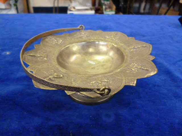 A white metal bon bon dish, possibly Indian, eight God figures to rim