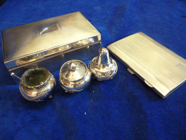 A George V silver cigarette box, also in the lot a George V silver cigarette case and three