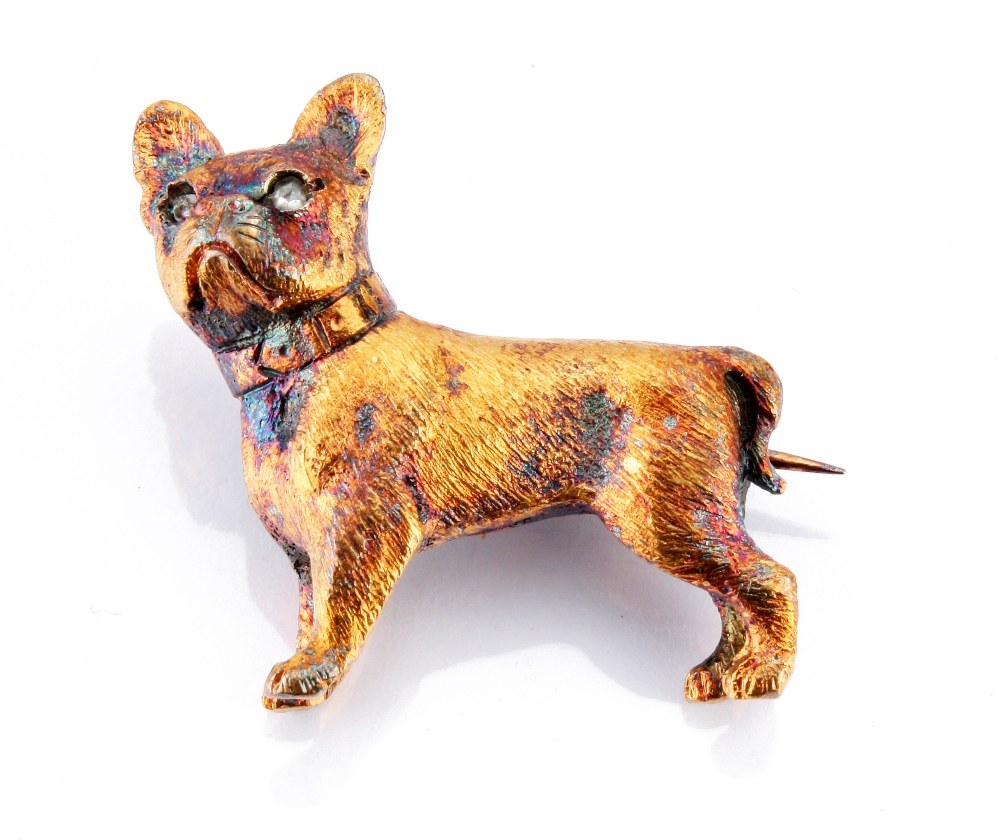 An amusing yellow metal dog brooch, modelled as a pug dog with rose cut diamond eyes approx. 6.4g