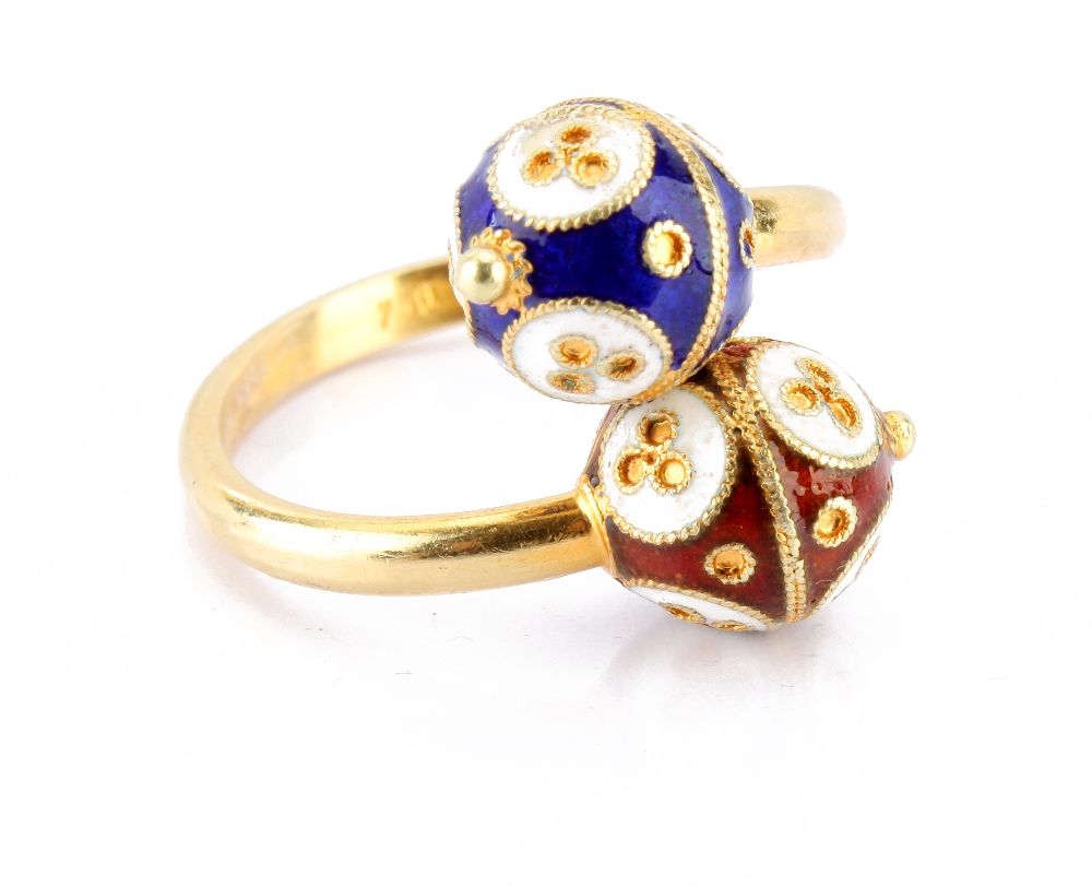 A modern 18ct gold and enamel cross over ring, having a blue and white, and a bronze and white