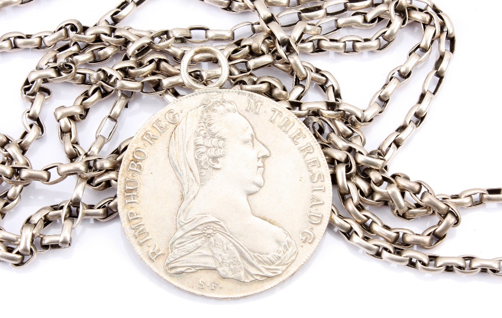 A silver muff chain, the opera length chain with oval links, together with a Maria Theresa Thaler