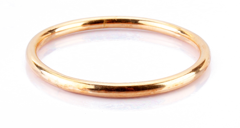 A 15ct gold bangle, the plain hoop marked 15ct and H.G & S approx. 11.8g