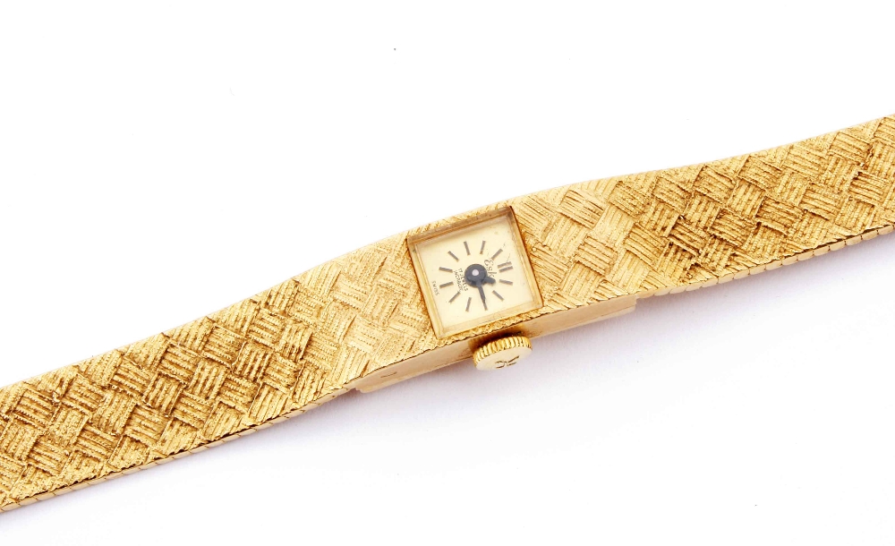 An 18ct gold Eska ladies wristwatch, the small square dial set into textured reticulated bracelet,