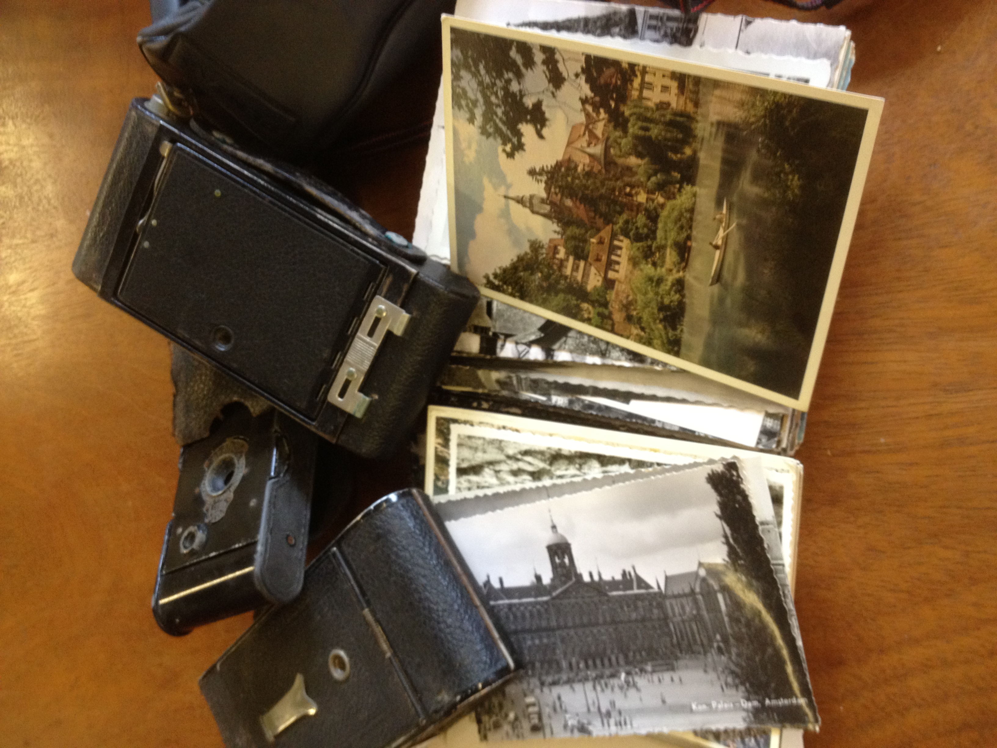 A group of four cameras, Kodak and others, together with a collection of postcards NO LIVE BIDDING