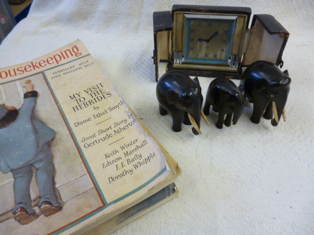 A Smiths travel clock in fitted case , together with three ebonised elephants, and three copies of