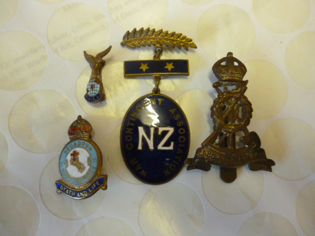 An enamelled badge for the 271 Squadron, cap badge, New Zealand War Contingent Association badge,