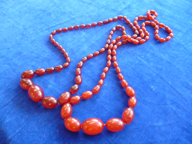 Two cherry amber necklaces, both with graduated beads (2) NO LIVE BIDDING FOR THIS SALE