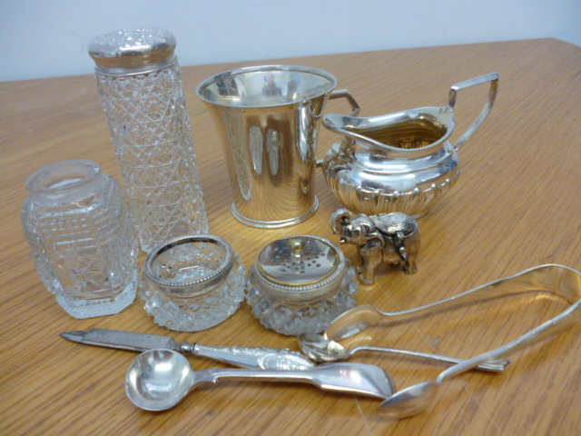 A small collection of silver plated items including a small tankard, sugar tongs, spoons etc (