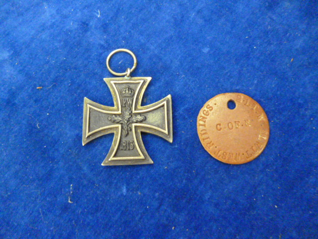 A WW I Iron Cross, together with a British Army dog tag NO LIVE BIDDING FOR THIS SALE