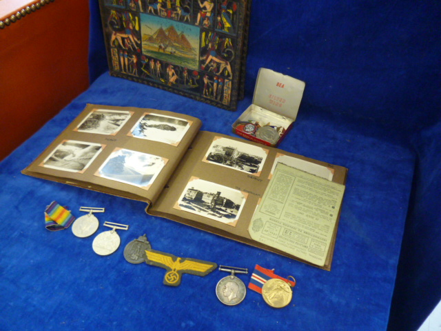 A group of RAF WWW II medals together with photo albums of the Middle East, badges and other items