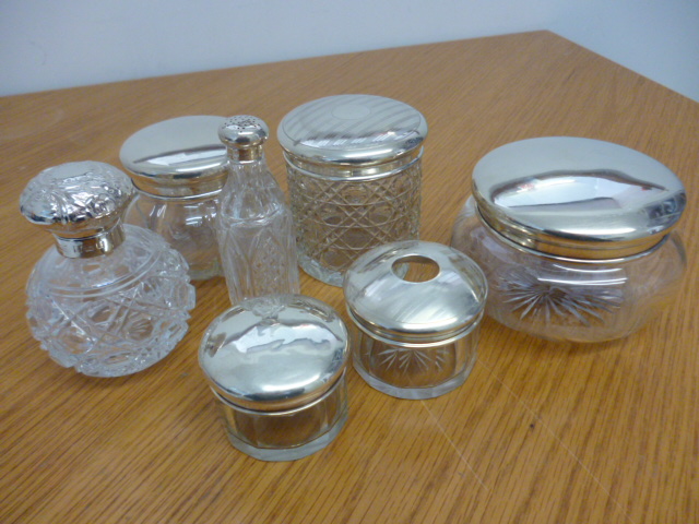 A collection of 7 various silver topped cut glass bowls and bottles (7) NO LIVE BIDDING FOR THIS