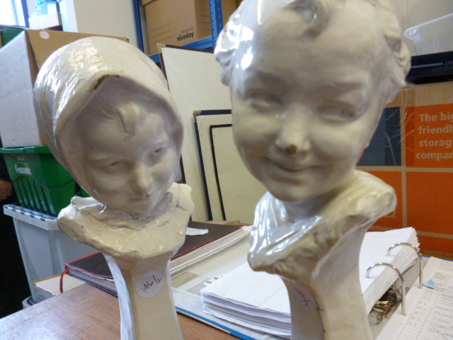 A pair of Faenza white glazed busts of children , a girl and a boy realistically modelled with