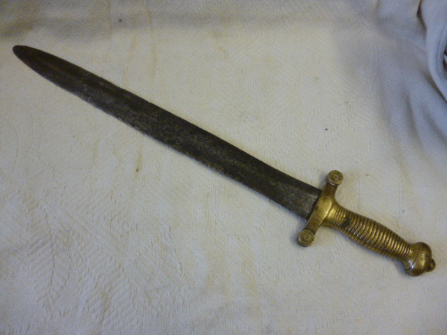 An 1831 artillery short sword,with brass handle and steel blade, with stamped marks and incised