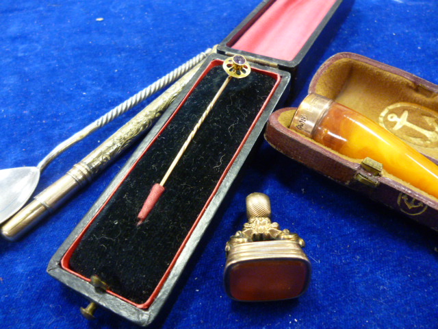 A 15ct gold stickpin together with an amber cigar holder, a seal, a spoon and a pencil (parcel) NO