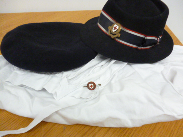 Two Wartime Red Cross hats together with nurses appron and British Red Cross Society pin badge (4)