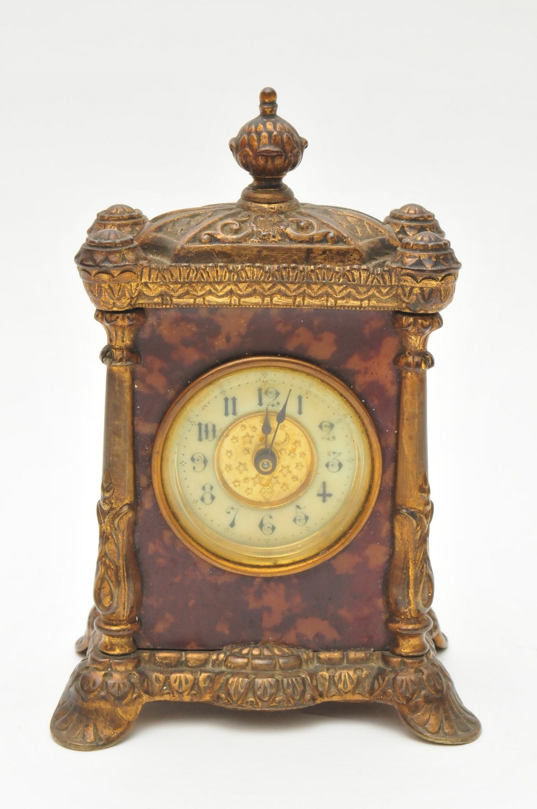 A small, Victorian gilt metal and simulated tortoiseshell mantle clock made by the British Clock