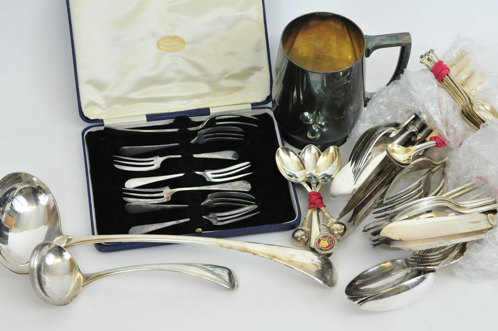 A large collection of silver plated and other flatware together with a silver plated tankard and