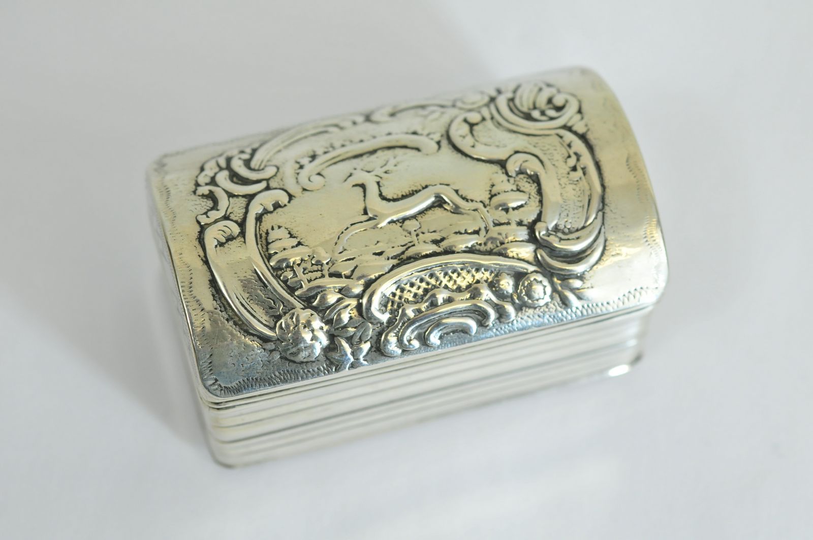 A small Dutch silver casket having repousse decoration of a Deer hunting scene bearing full