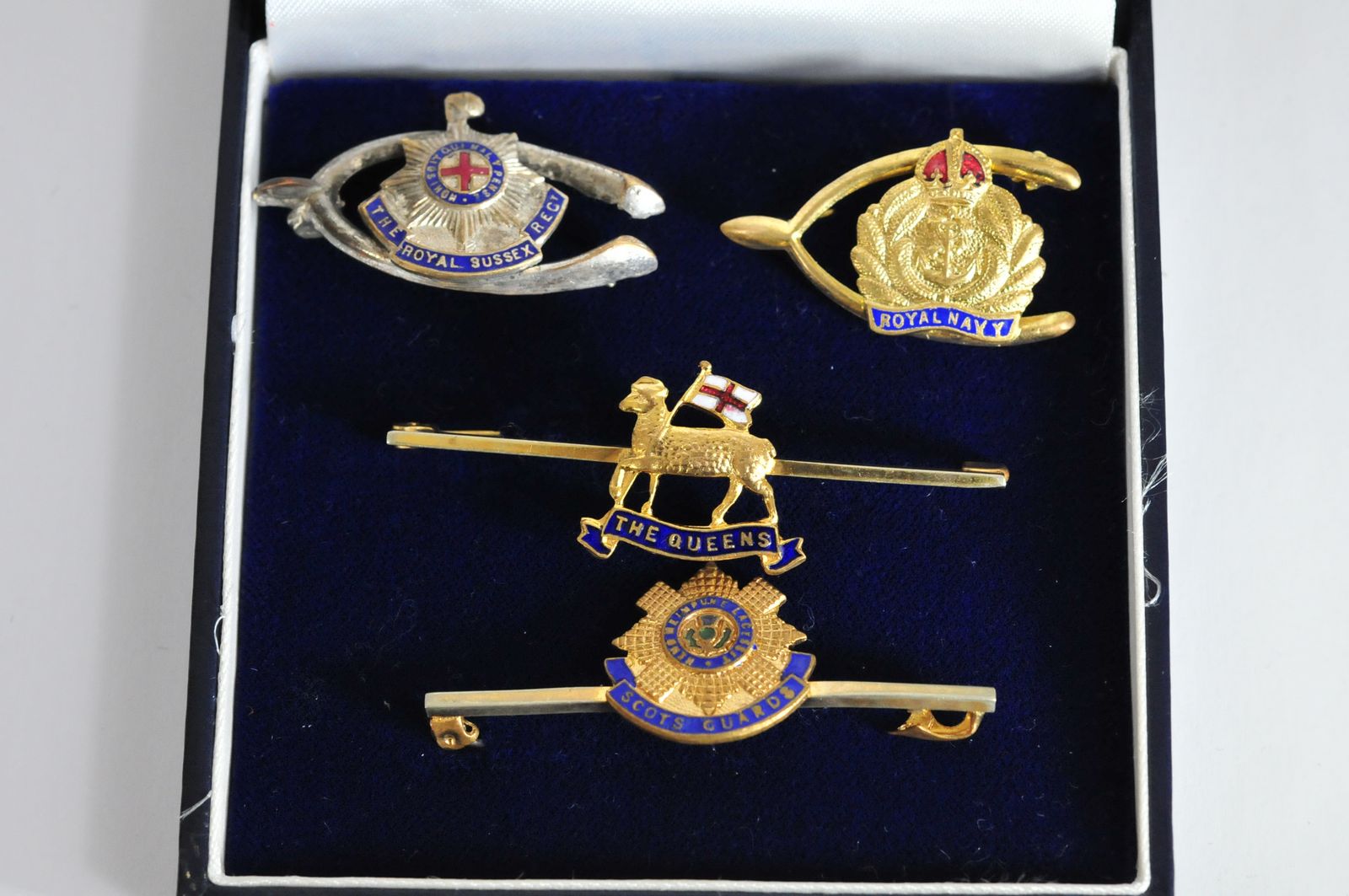 A group of four brooches of Military interest, two in the form of a wishbone with enamel detail