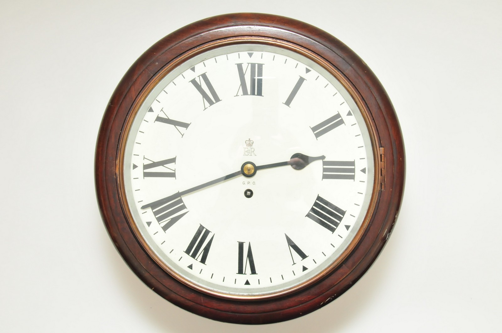 A single fusee GPO dial clock, the white enamel dial having Roman numerals and with Queen