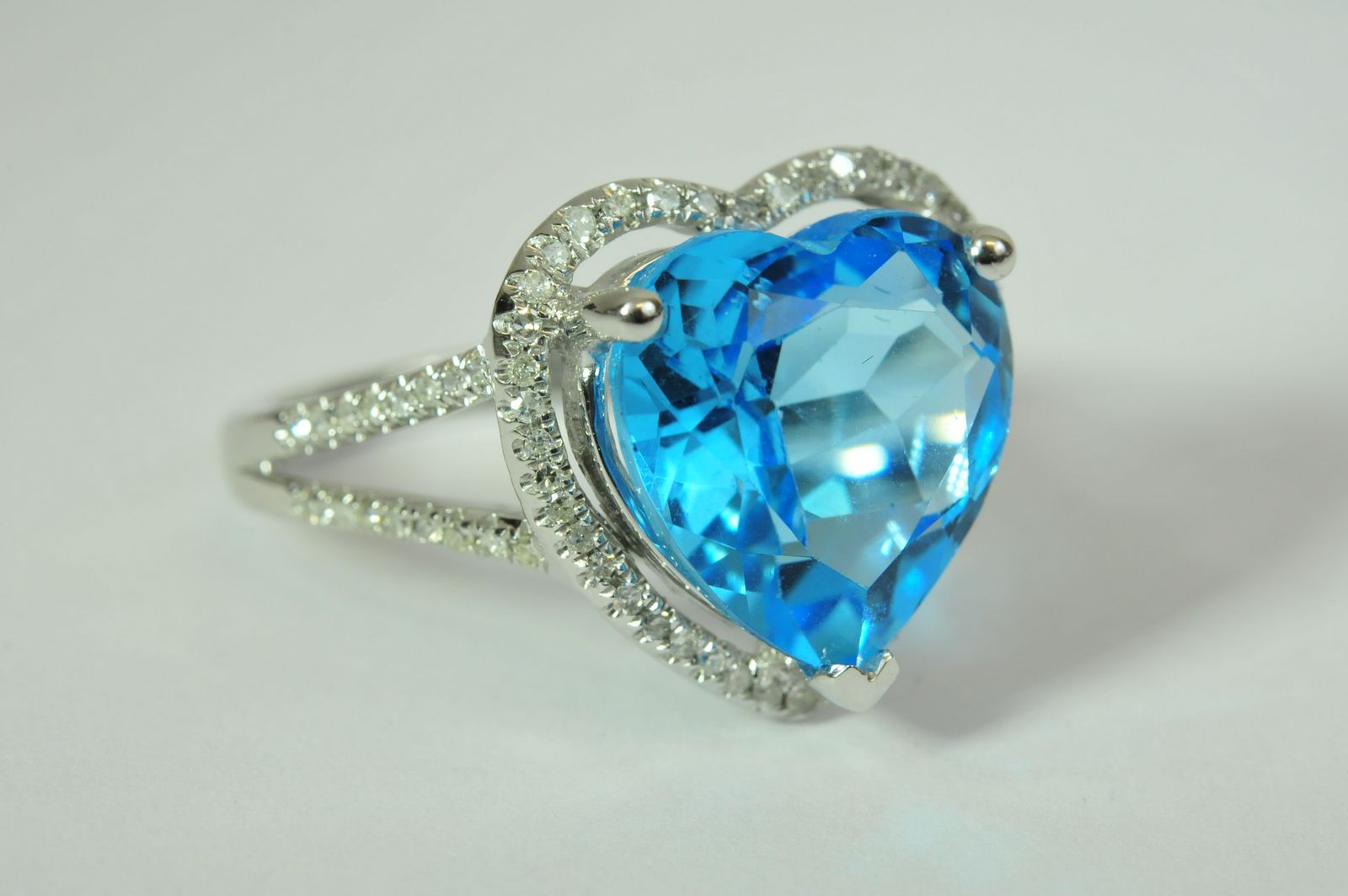 A 14K white gold and diamond ring set with a heart shape blue topaz approximately 6.75 ct diamonds