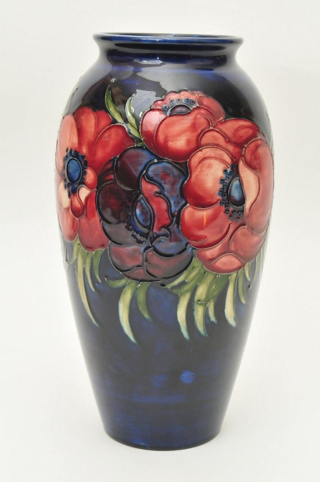 A 1920s Moorcroft Anemone pattern vase having tube lined decoration of flowers and foliage on a deep