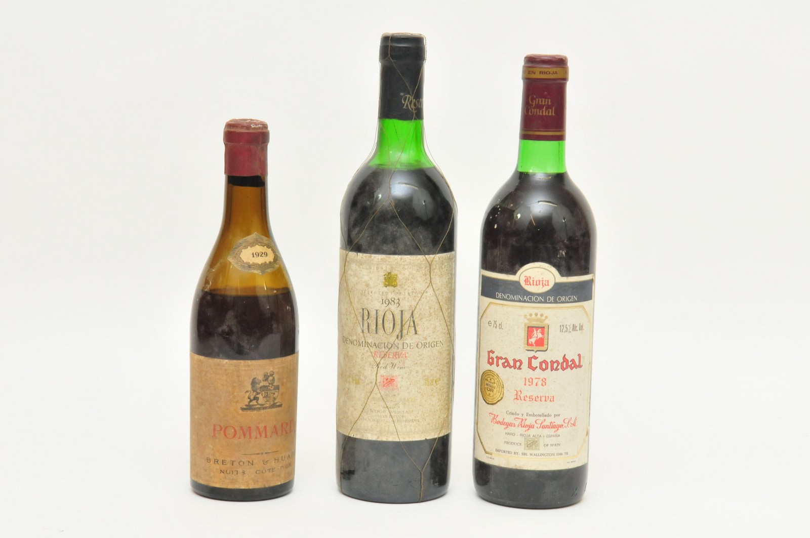 Three vintage bottles of wine comprising a 1929 Pommard, and two bottles of Rioja dated 1978 and