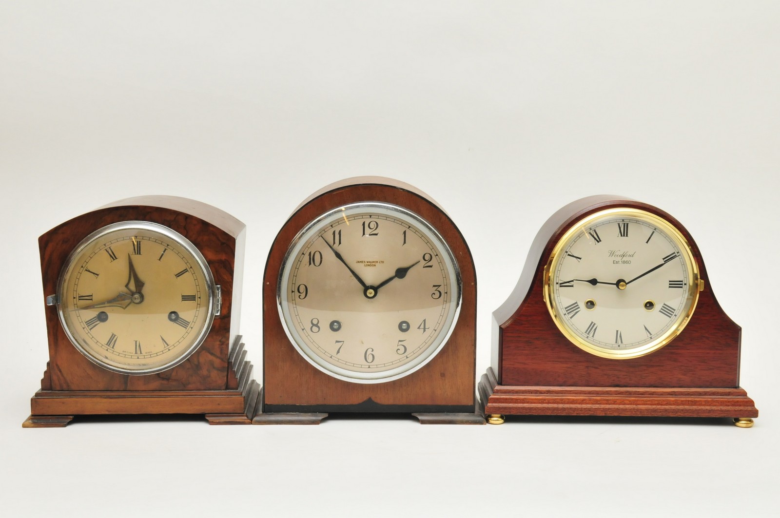 A collection of three mantle clocks comprising a modern Woodford mantle clock, a figured walnut