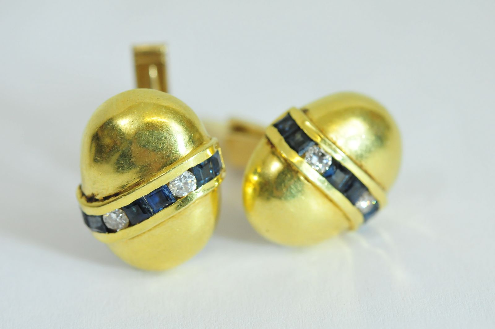 A pair of 18ct yellow gold cufflink's of oval shape channel set with a single row of carre cut