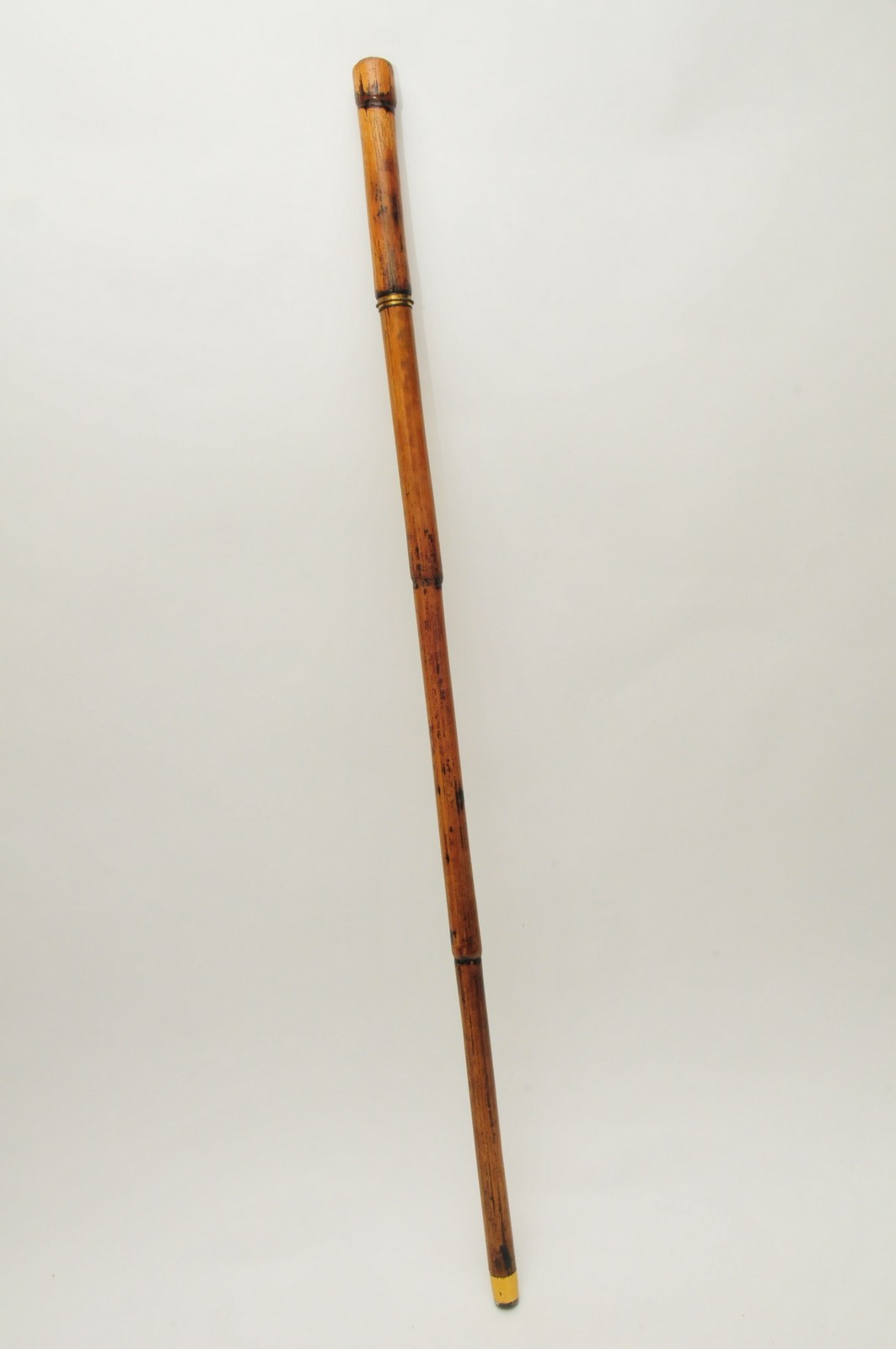 A Victorian sword stick with bamboo handle and case and brass finial.