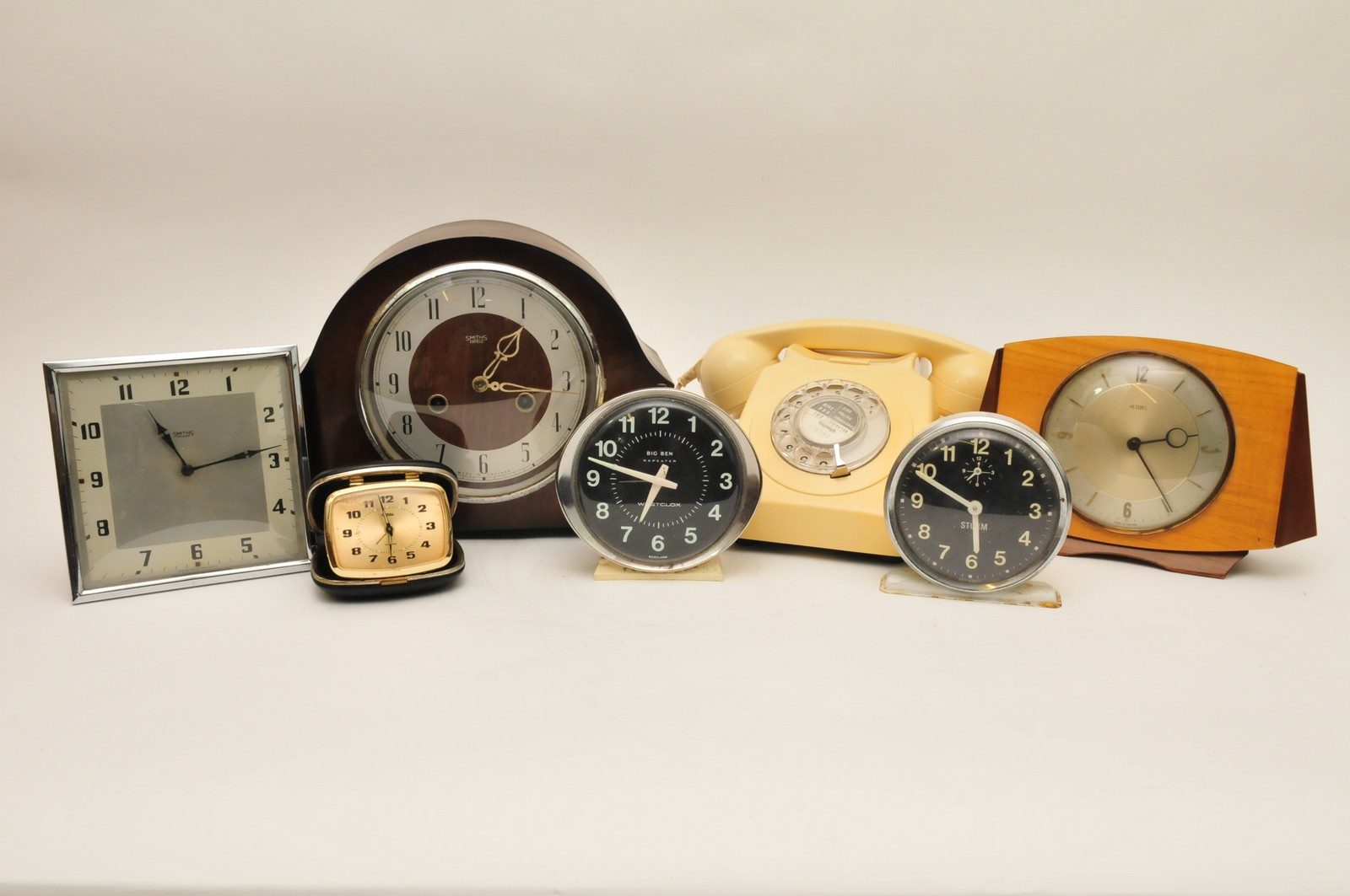 A Smiths mantle clock with box containing various others and a vintage telephone