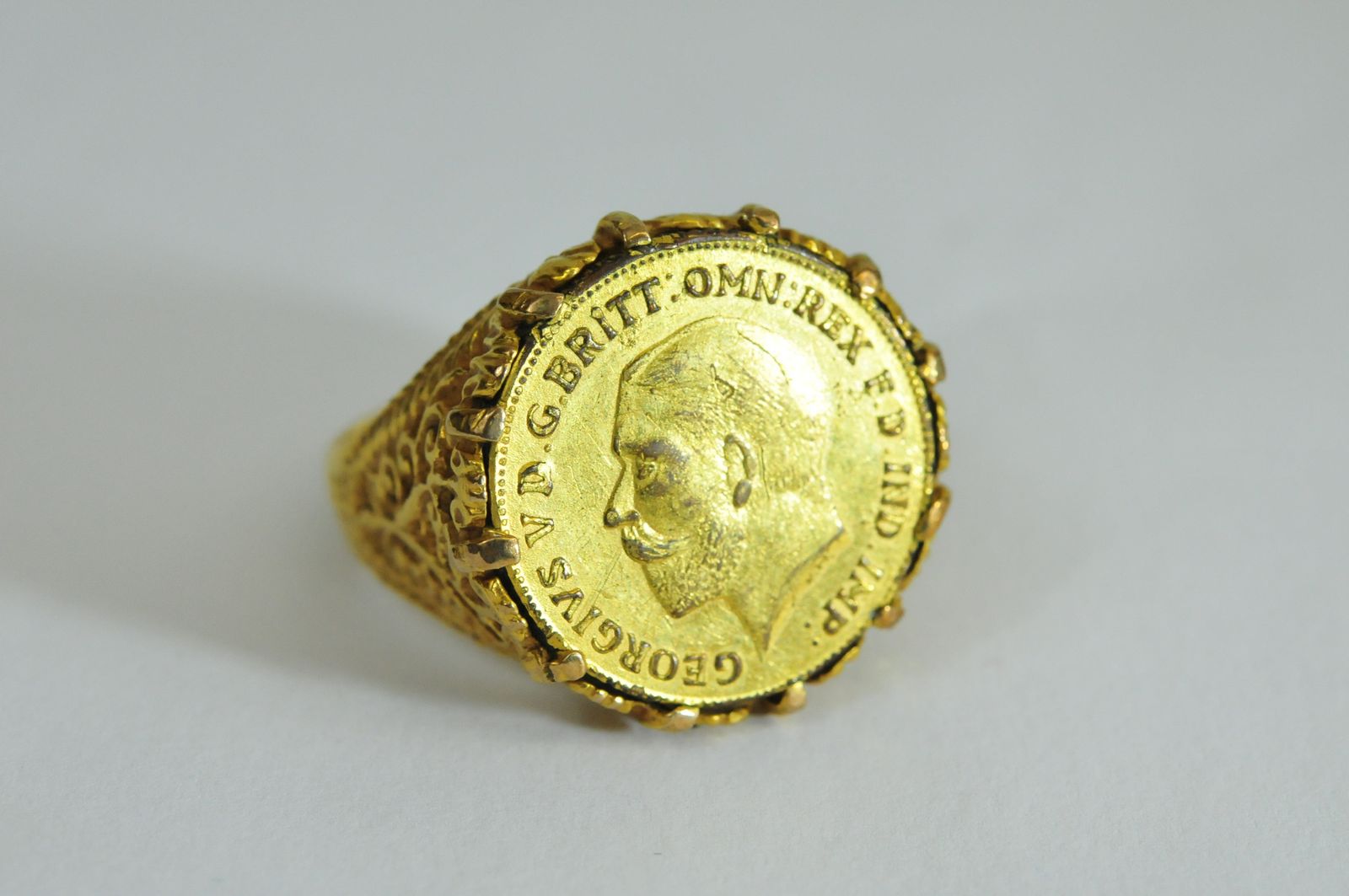 A 9ct gold coin ring set with a simulated sovereign